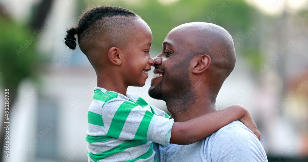 Father and son doing eskimo kiss. African black dad and child bonding together. Family love and affection Father and son doing eskimo kiss. African black dad and child bonding together. Family love and affection