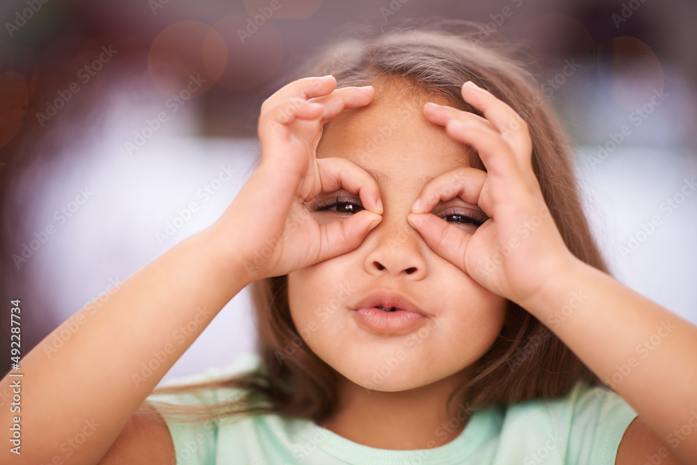 I see you. Shot of a playful little girl with pulling a funny face. I see you. Shot of a playful little girl with pulling a funny face.