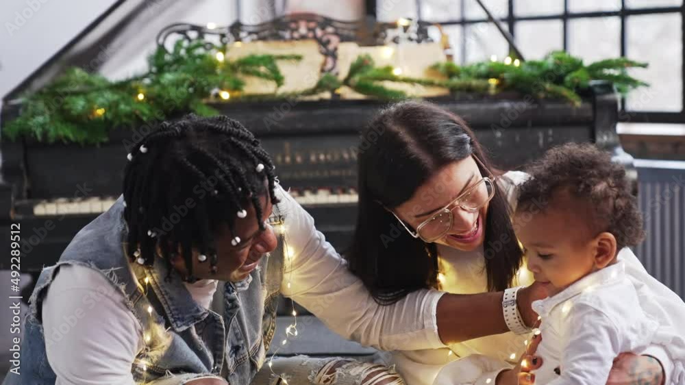 Adorable baby spending his first Christmas with loving multiracial parents. High quality 4k footage Adorable baby spending his first Christmas with loving multiracial parents. High quality 4k footage