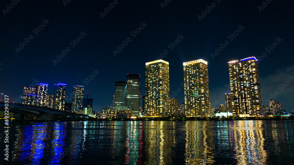 Night view of a high-rise condominium along an urban river_39
