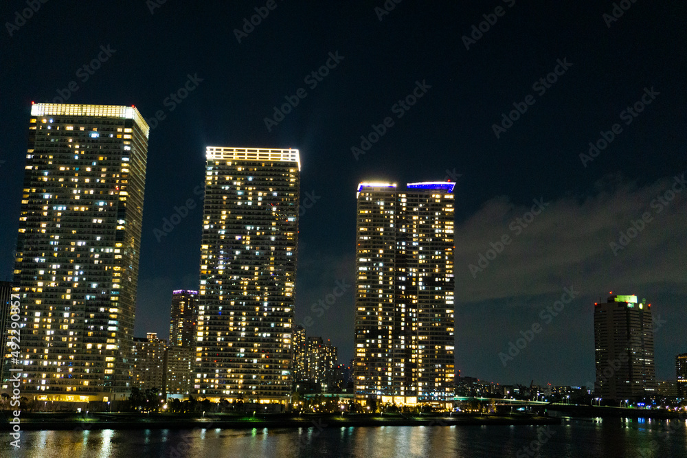 Night view of a high-rise condominium along an urban river_46