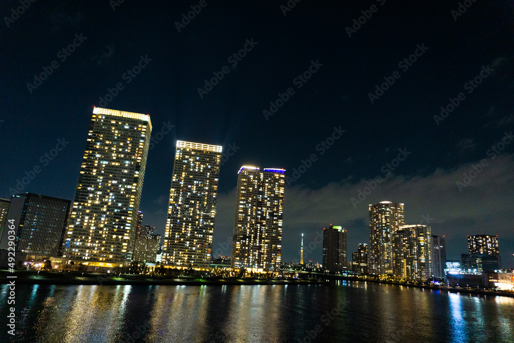 Fototapeta premium Night view of a high-rise condominium along an urban river_48