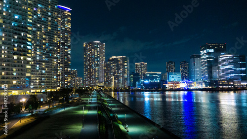 Night view of a high-rise condominium along an urban river_36