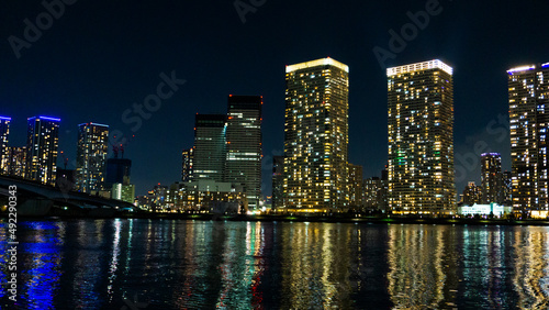 Night view of a high-rise condominium along an urban river_42