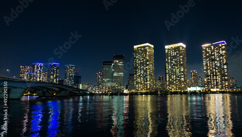 Night view of a high-rise condominium along an urban river_44