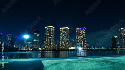 Night view of a high-rise condominium along an urban river_45