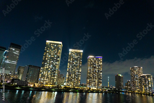 Night view of a high-rise condominium along an urban river_49
