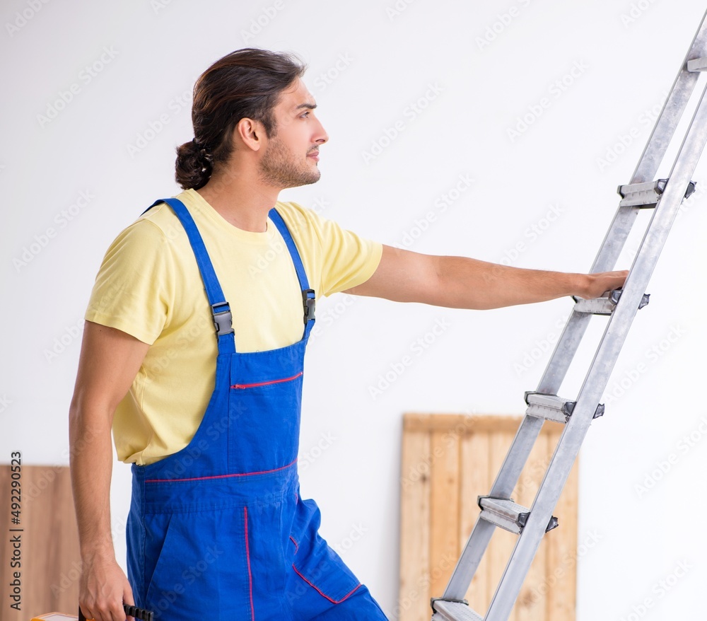 Young male contractor working indoors Young male contractor working indoors
