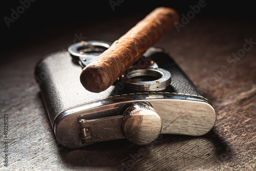 One cigar on cutter and leather hip-flask photo