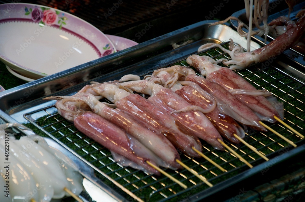 BBQ Squid on a Stick. grilled buttered fresh squid ready to eat ...