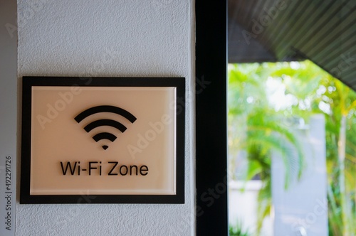 Wireless internet sign on the wall near with sun bed on the grass field, relaxing and working business area