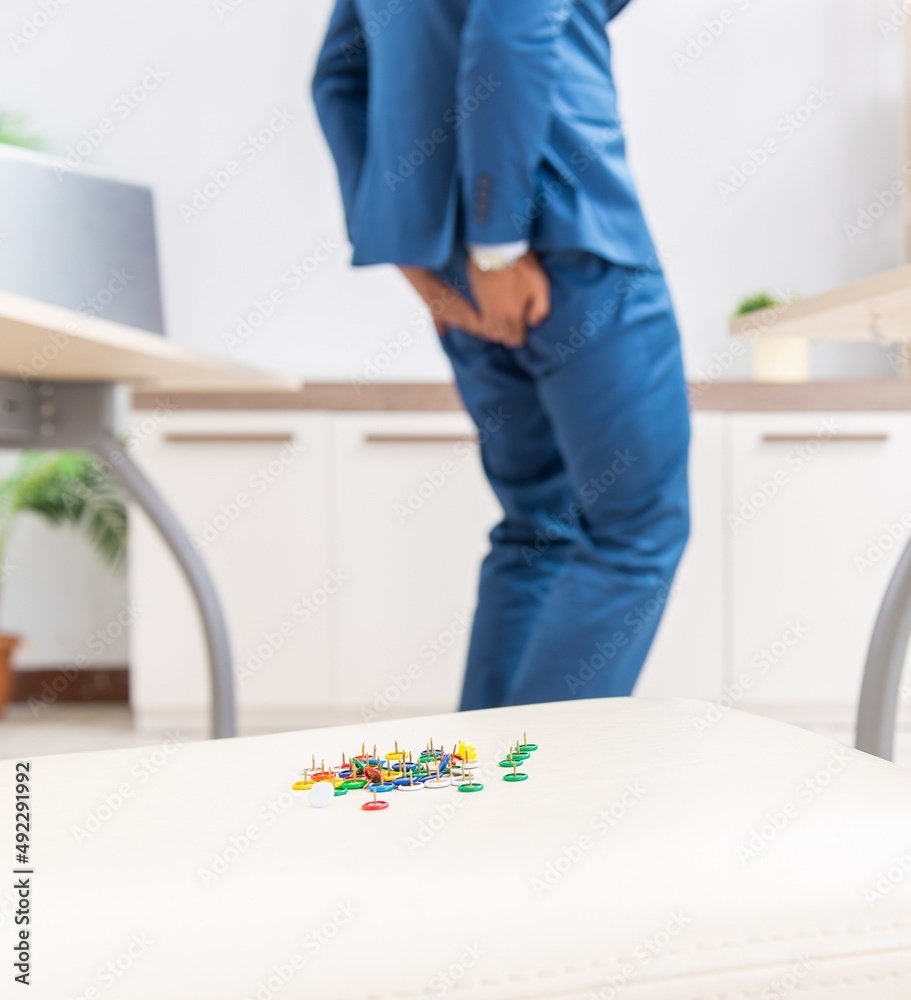 Fototapeta premium The office prank with sharp thumbtacks on chair