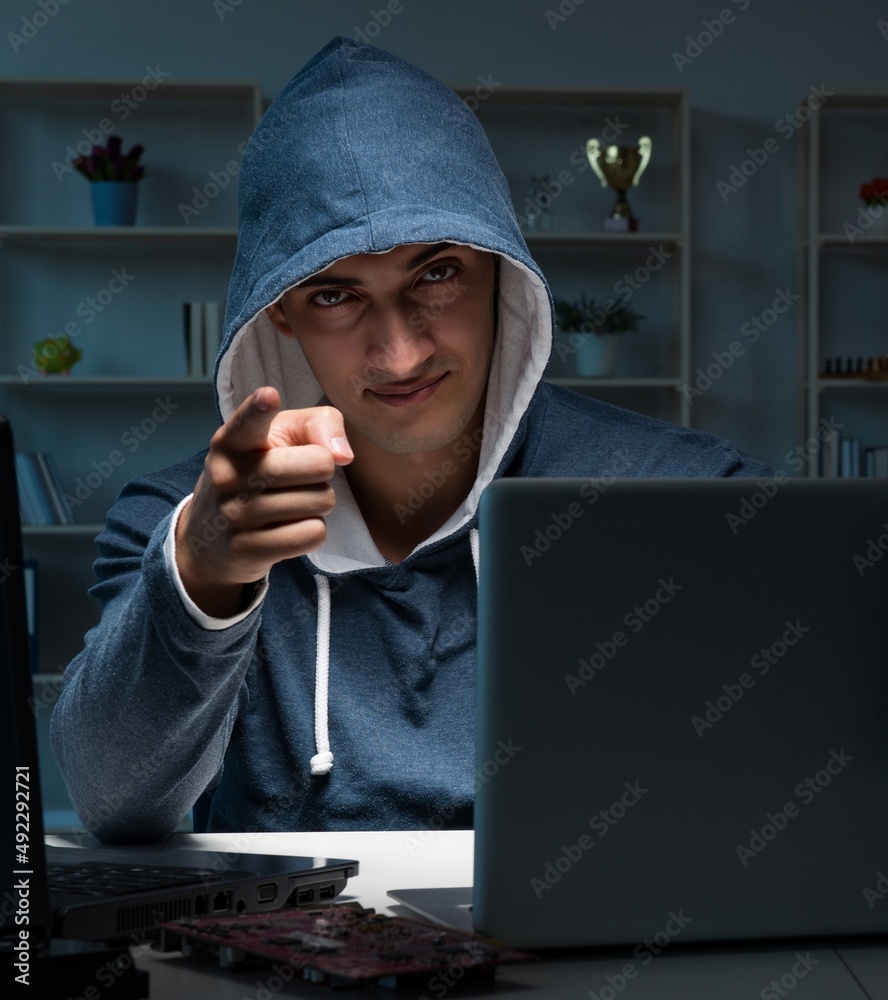 Hacker hacking computer at night Hacker hacking computer at night