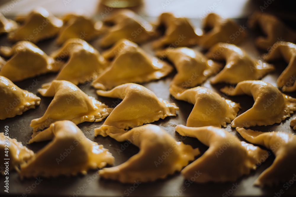 Empanada dough before going into the oven in a dish. Pastry concept, bakery. Empanada dough before going into the oven in a dish. Pastry concept, bakery.