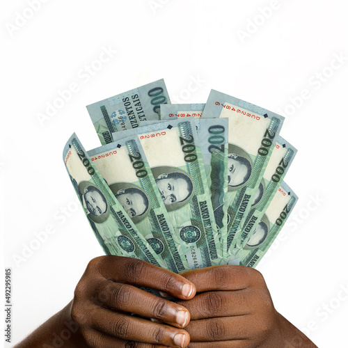 Black hands holding 3D rendered 200 Mozambican metical notes. closeup of Hands holding Mozambican currency notes photo