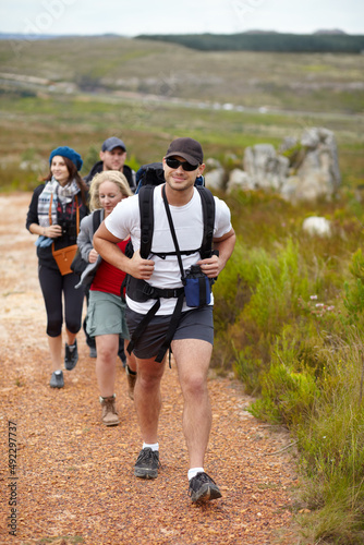 They enjoy hitting at trail. A happy group of friends walking the hiking trails together.