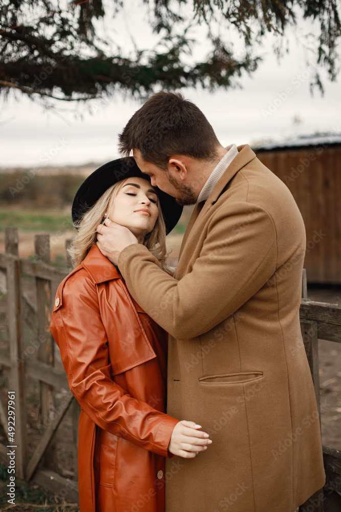 Romantic couple hugging on a farm near a fence Romantic couple hugging on a farm near a fence