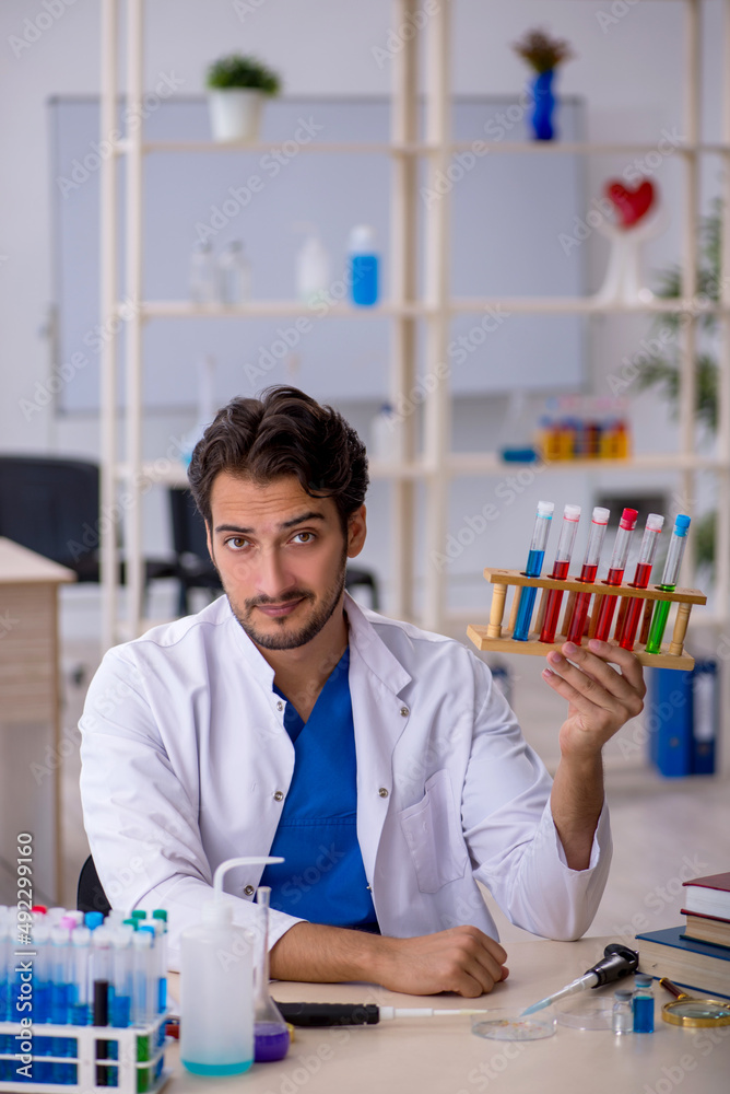 Young male chemist working at the lab Young male chemist working at the lab