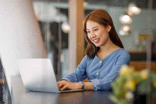 Shot of a asian young business woman working on laptop computer in her workstation.Portrait of Business people employee freelance online marketing e-commerce telemarketing concept.