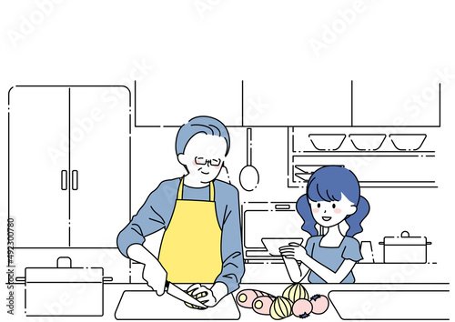 料理をするシニア男性とお手伝いする孫