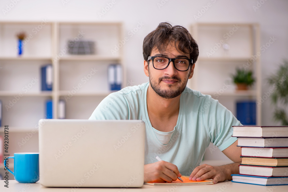 Young male student preparing for exams in the classroom Young male student preparing for exams in the classroom