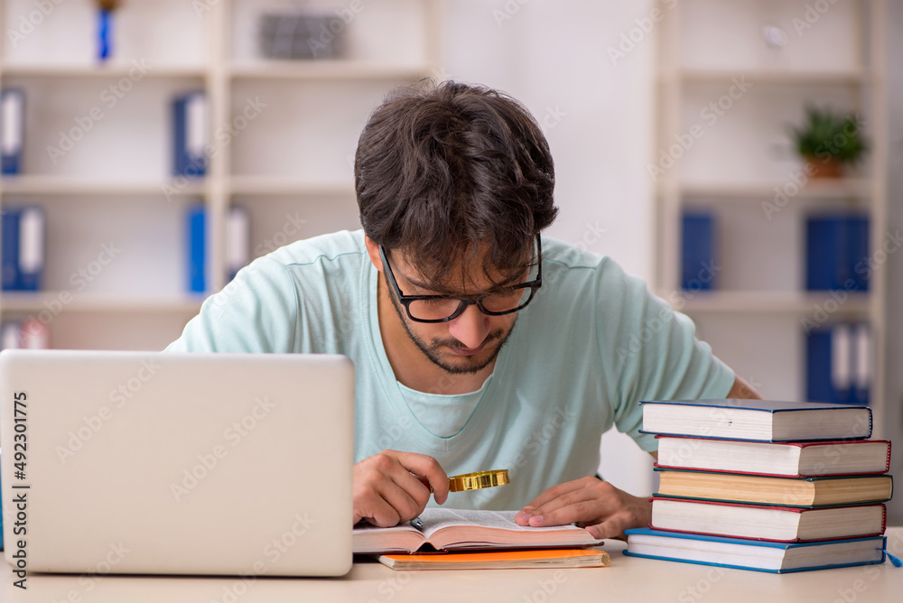 Young male student preparing for exams in the classroom Young male student preparing for exams in the classroom