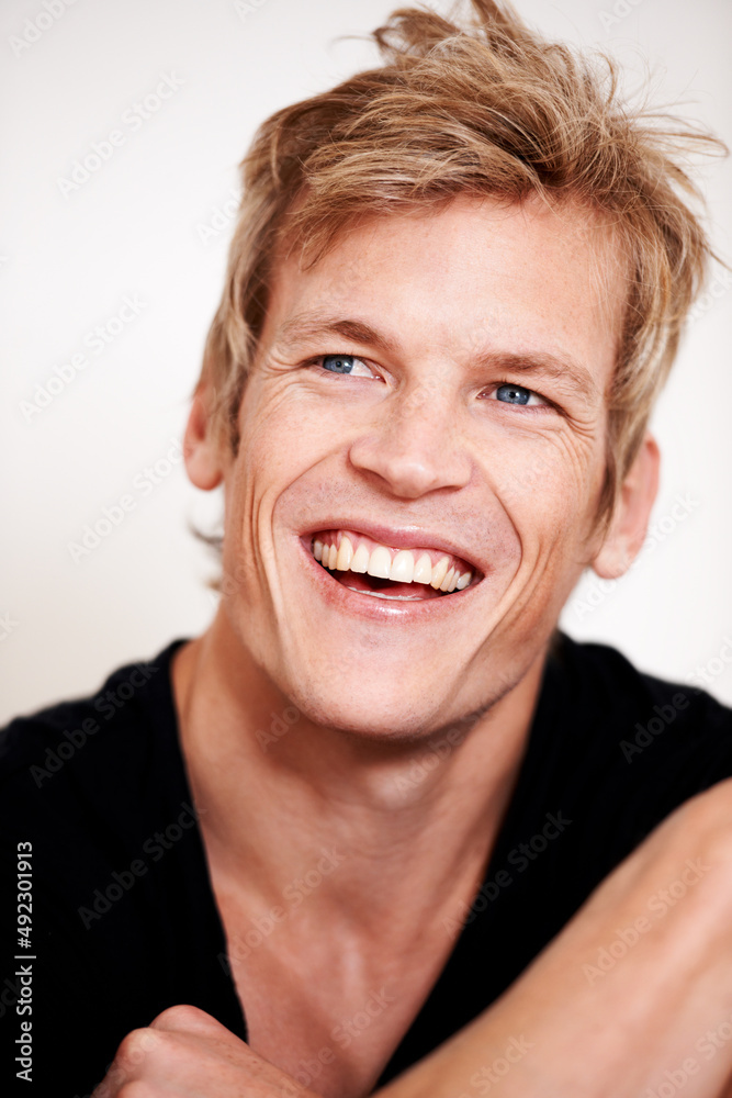 Sensational smile. Cropped shot of a handsome young man posing in studio. Sensational smile. Cropped shot of a handsome young man posing in studio.