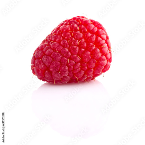 One ripe raspberry isolated on white backdrop.
