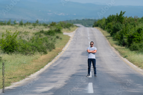 Portrait of Muscular Man Standing Outdoors at Highway