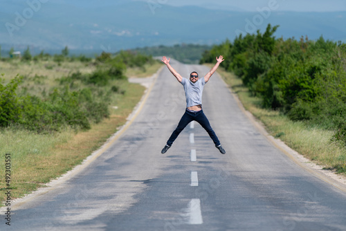 Muscular Man Jumping Outdoors at Highway