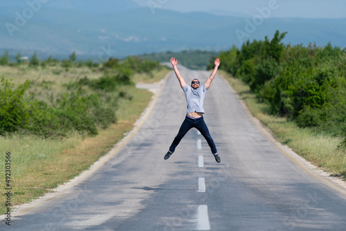 Muscular Man Jumping Outdoors at Highway