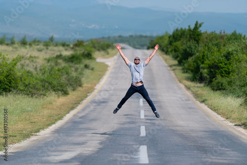 Muscular Man Jumping Outdoors at Highway © Jale Ibrak