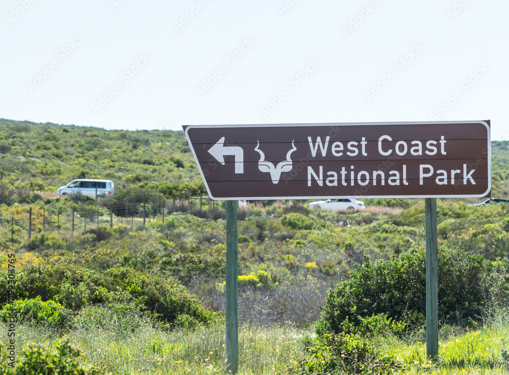 Obraz premium West coast national park road sign or signage showing directions to a place of interest in Western Cape, South Africa