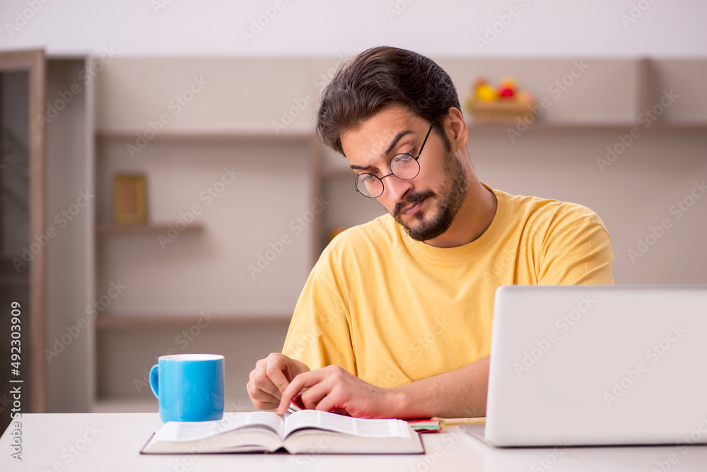 Young male student preparing for exams at home Young male student preparing for exams at home