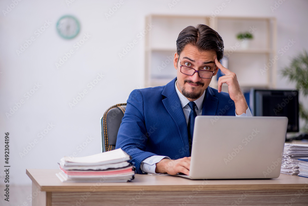 Young male employee working in the office Young male employee working in the office