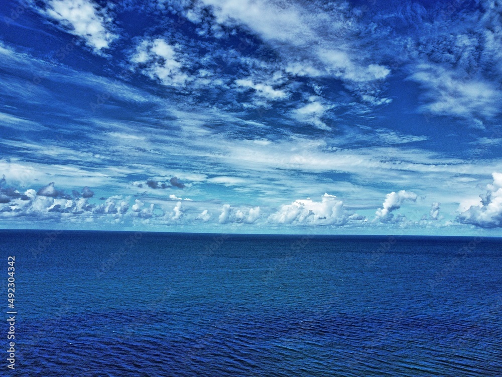 Aerial view of blue ocean and powerful white clouds Aerial view of blue ocean and powerful white clouds