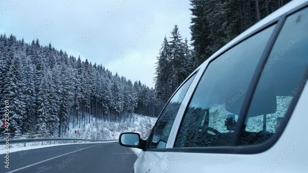 car on the roadside in winter against the background of the forest. emergency headlight
