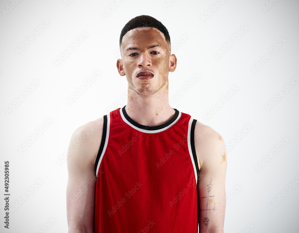 Game face, on. Cropped portrait of a handsome young male basketball player posing in studio. Game face, on. Cropped portrait of a handsome young male basketball player posing in studio.