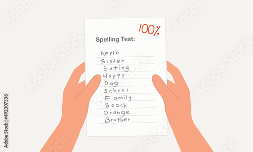 Close-Up View Of A Student’s Hand Holding A Spelling Test Paper With Full Marks.