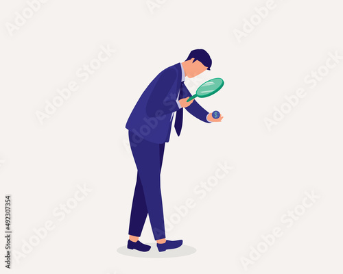 Currency Depreciation Concept. Man With Magnifying Glass Looking At The Coin In His Hand.