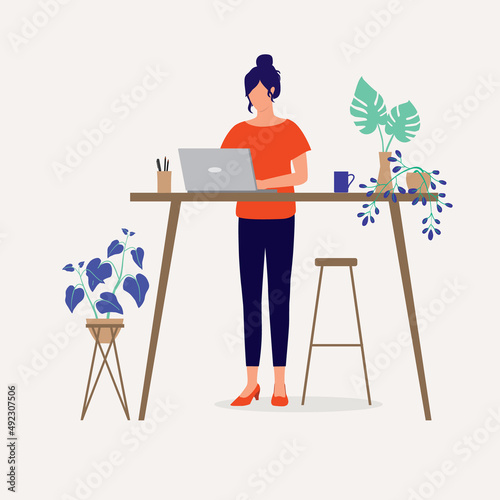 Young Businesswoman With Laptop Working At Standing Desk.