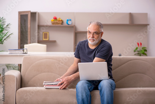 Old male employee working from home during pandemic