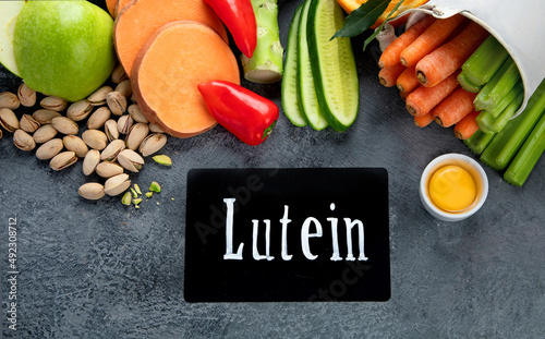 Foods high in lutein on dark background. photo