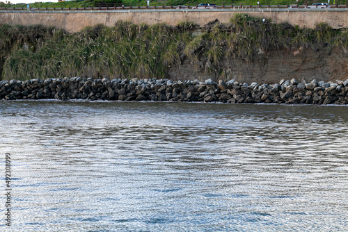 Riprap along California coast providing erosion control for a sea wall photo