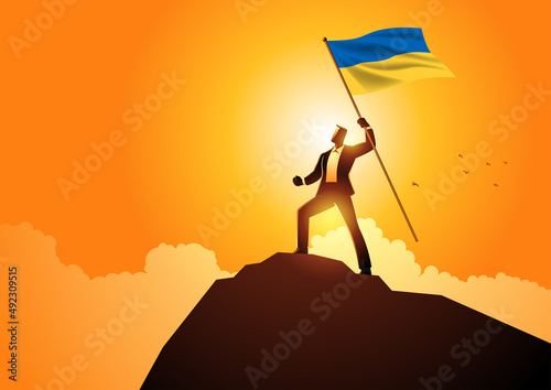 Man optimistically standing on a mountain holding the flag of Ukraine