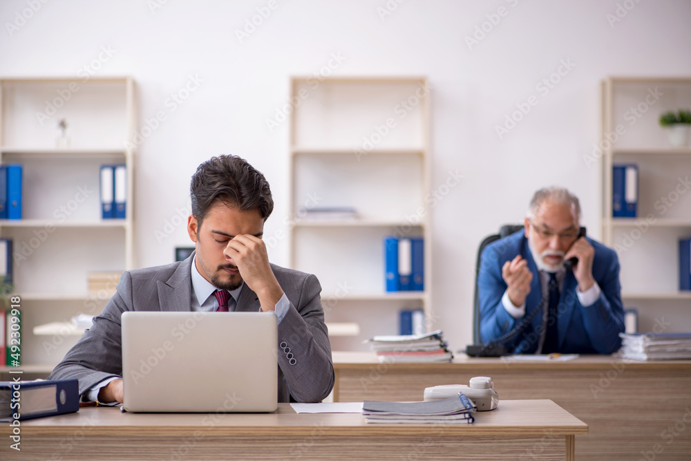 Two male colleagues working in the office Two male colleagues working in the office
