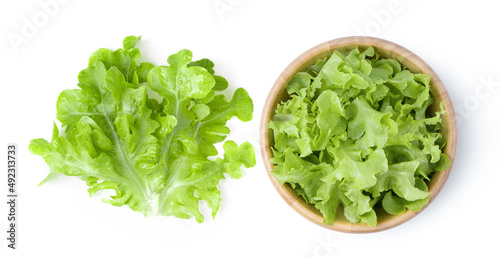 lettuce leaf in wood bowl isolated on white background