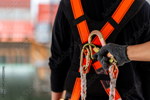 Obraz na plátne Construction worker wearing safety harness and safety line