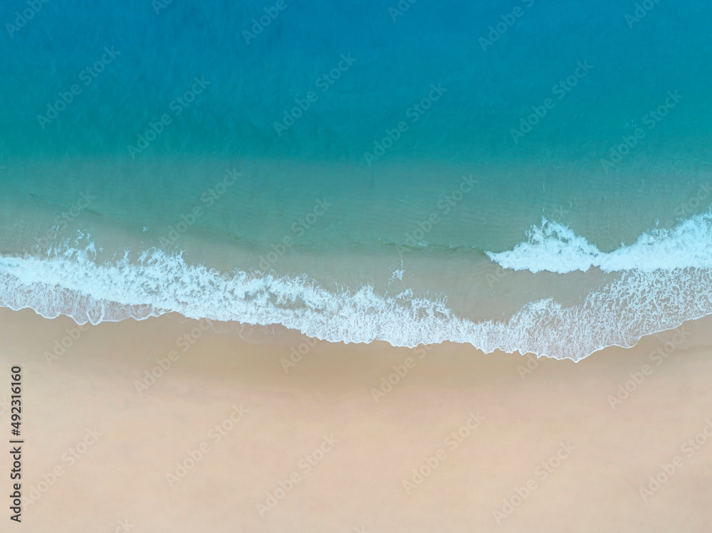 Top view of the Coast with waves as a background from aerial view. Blue water background from drone. Summer seascape from above  Travel