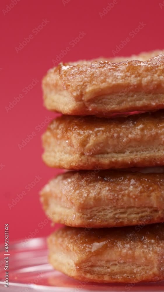 Close-up: puff pastry biscuits rotate on a stand in a glass cloche